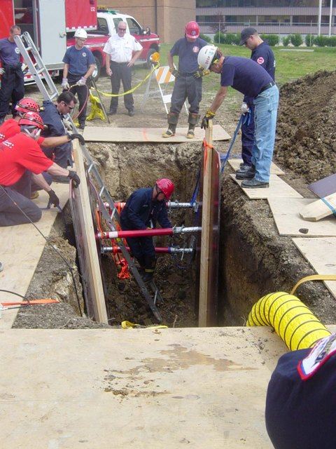 Members of Division 1 Technical Rescue Teams work together at a live trench drill.