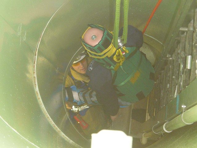 Mannequin, simulating a victim, is removed from a below-ground space at a confined space training.